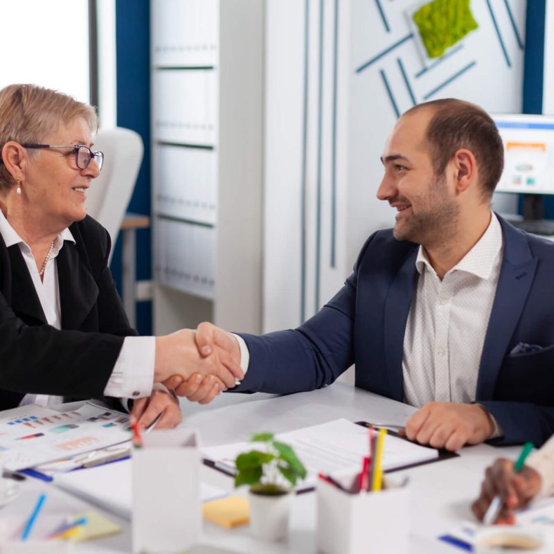 consultant-greeting-international-client-with-handshake-after-partnership.jpg