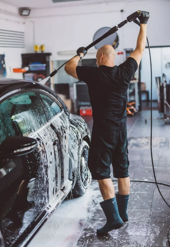 service-man-washing-car-before-detailing-in-worksh-2025-03-24-09-20-22-utc